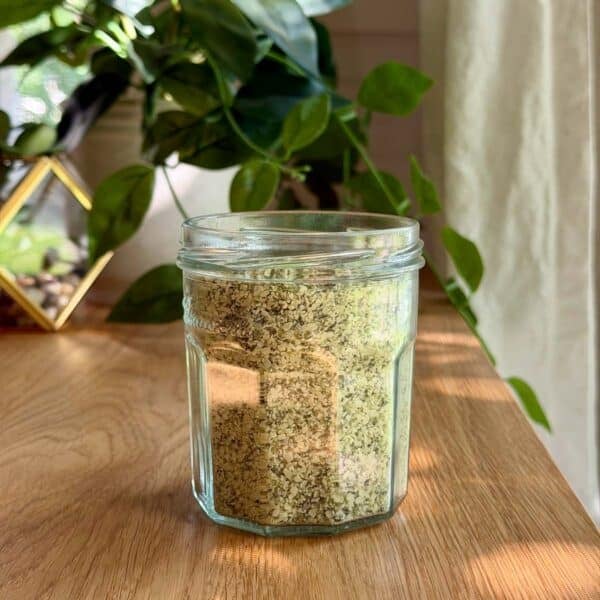 a jar of basil salt on a table