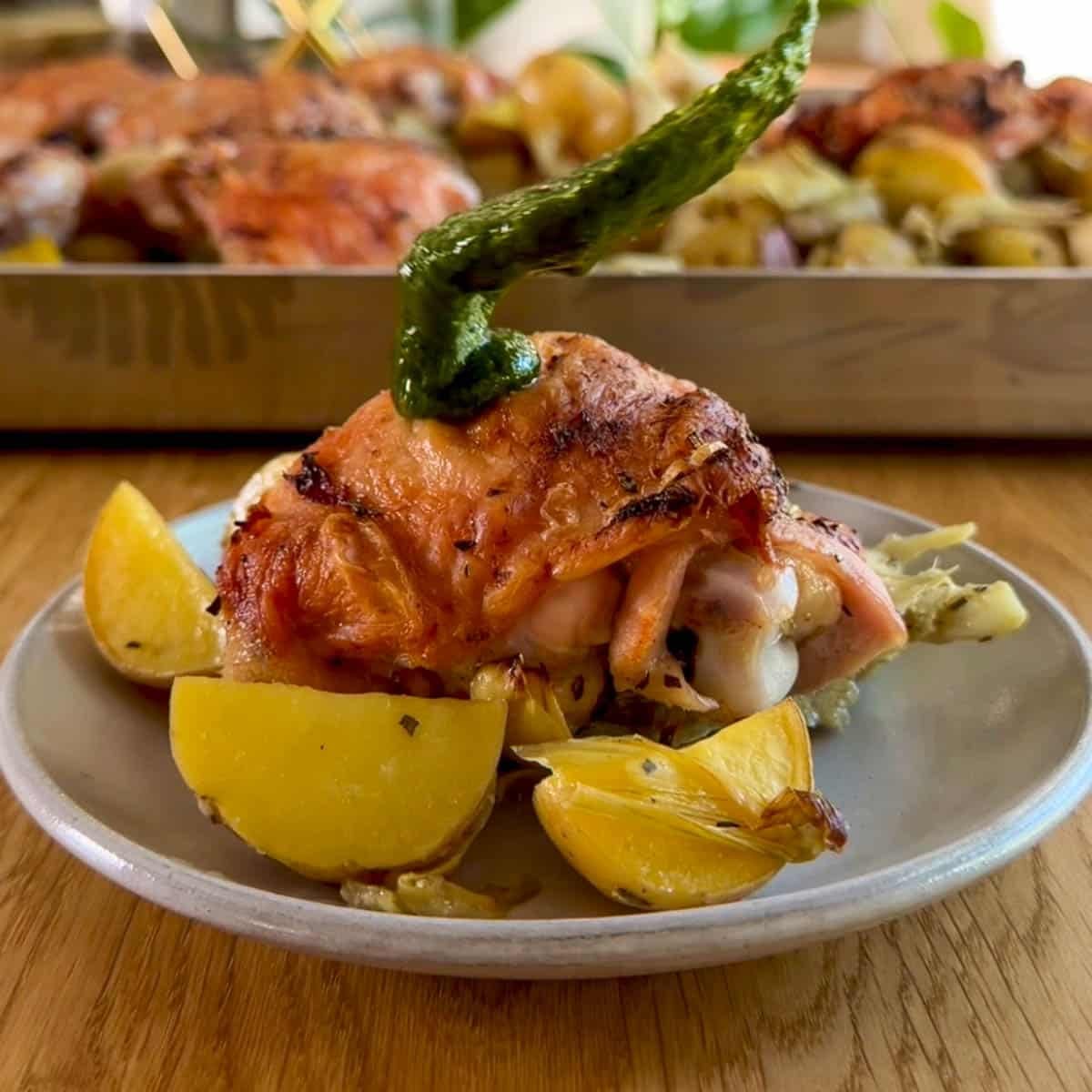 putting herb sauce on a chicken thigh