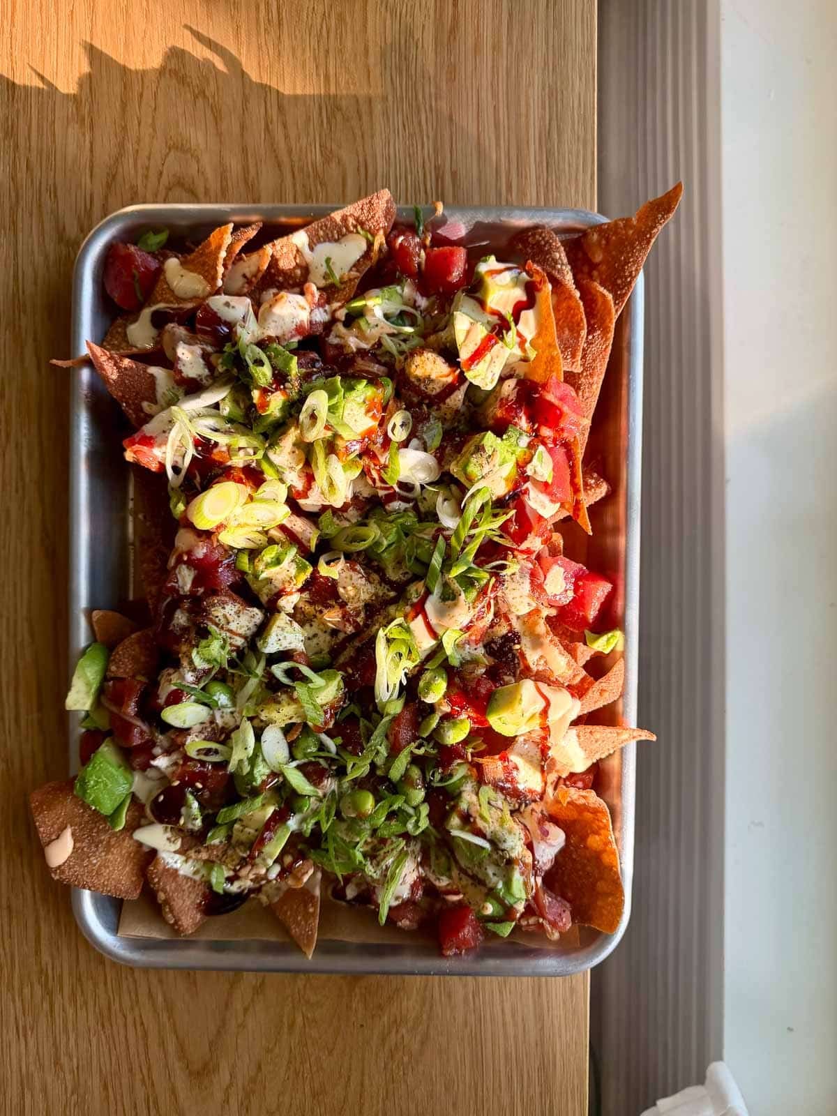 spicy tuna poke nachos on a quarter sheet pan